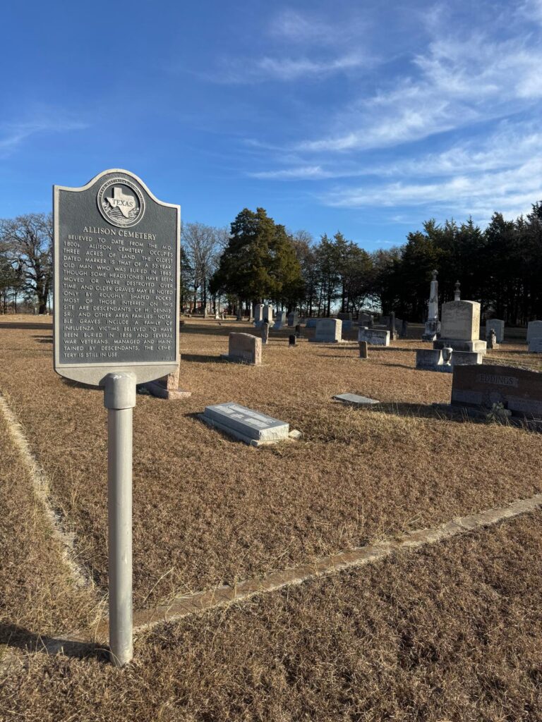 cemetery near Sherman, Texas with headstones and a Texas historical marker under a clear sky