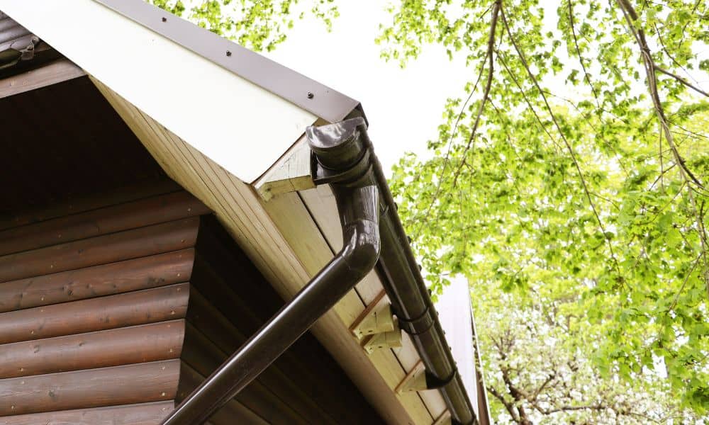 Roof downspout connected to gutter system directing rainwater away from a home