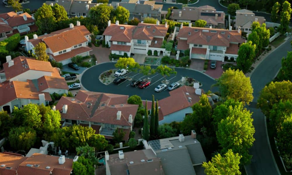 Aerial view of a residential cul de sac with houses surrounding a circular street, showing limited traffic and green landscaping