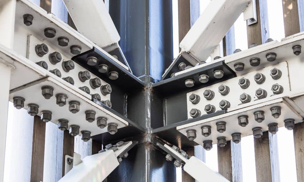 Close-up of gusset plates connecting structural steel beams with bolted joints in a construction framework